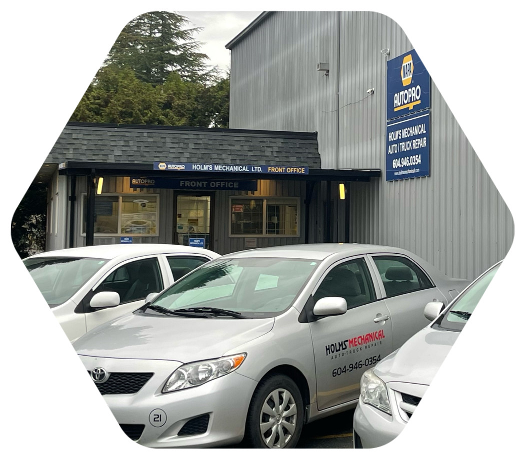 Front view of Holm’s Mechanical LTD. building with courtesy vehicles parked out front, highlighting our convenient services for customers.